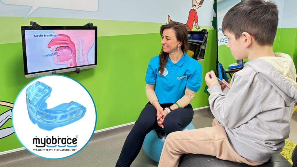 Myobrace consultation at Optident Dental Clinic in Colchester, showing a dentist explaining treatment to a young patient in the dedicated Myobrace room.