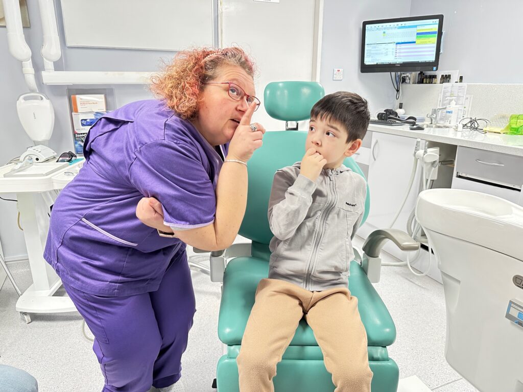 Principal Dentist Dr. Liana at Optident Dental Clinic in Colchester guiding a young Myobrace patient during an orthodontic consultation.