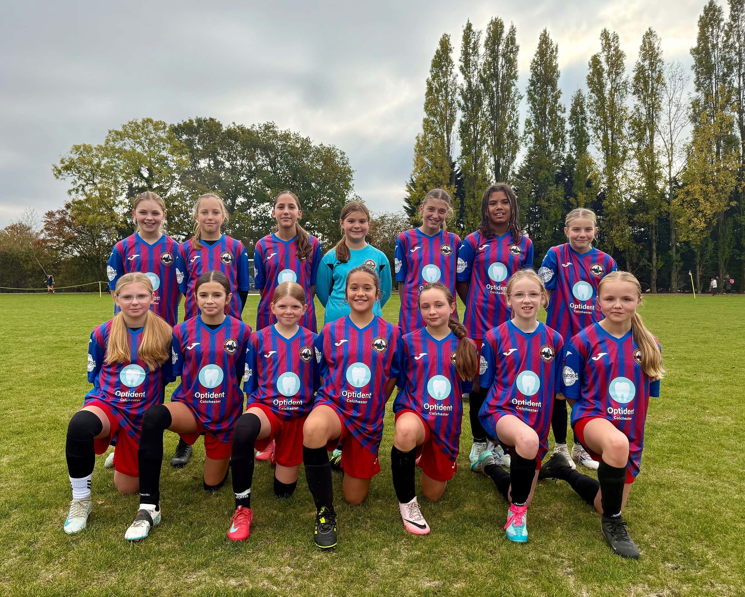 Wivenhoe Tempest Girl Team sporting their new Optident branded kits ahead of their football season